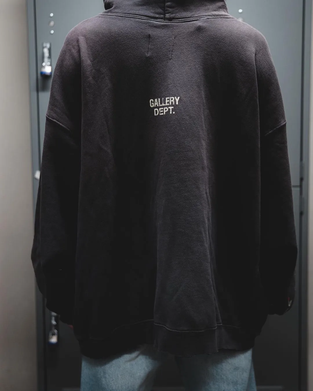GALLERY DEPT. 90'S RECYCLE HOODIE WASHED BLACK 90'S washed hoodie with distressed eco-friendly slogans. Washed black S-XL. Ready-made garments are washed and dyed again. Multiple spots throughout the body are spray-faded. The ribs are cut and worn.